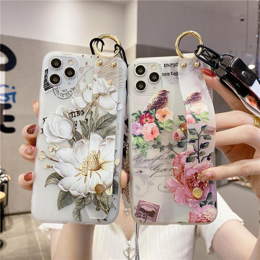 Funda blanda para iPhone con soporte para correa de muñeca con flores en relieve